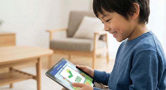 Child practicing math on a tablet with an online learning platform